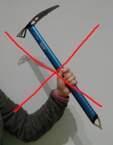 incorrect holding of ice axe